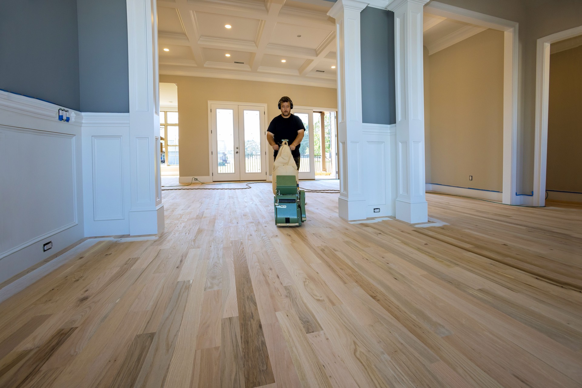 A process of grinding a wooden parquet floor by using a floor sander in a newly constructed house to ensure that it is smooth and even